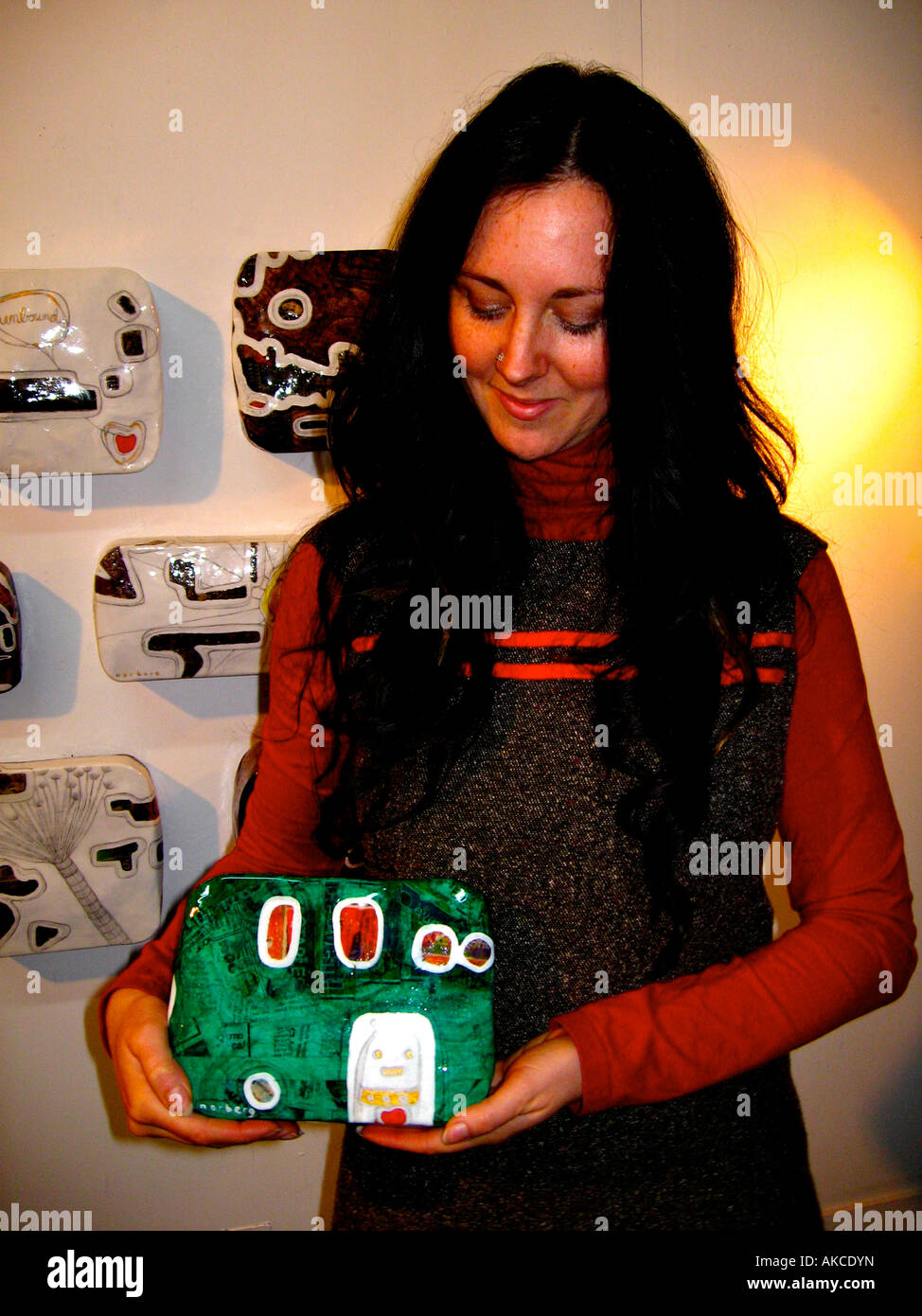 Mixed media artist with some of her paper maché works. Stock Photo