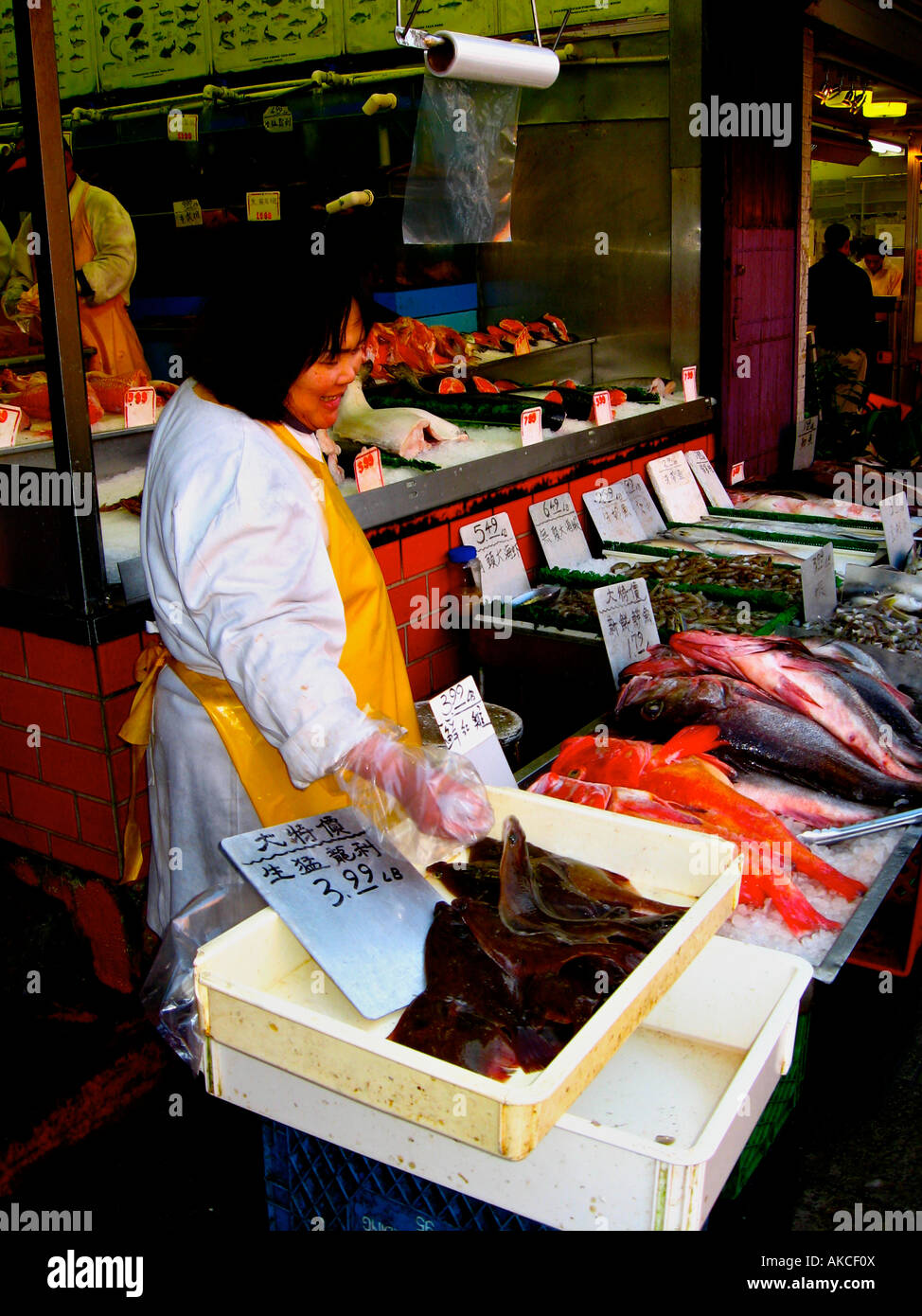 Woman selling fresh fish in Vancouver's Chinatown. Stock Photo
