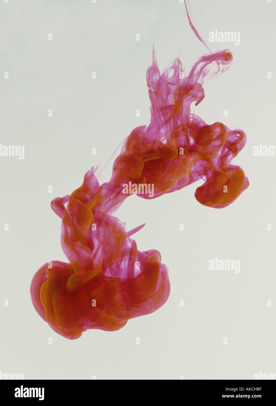 Red ink billowing in water Stock Photo