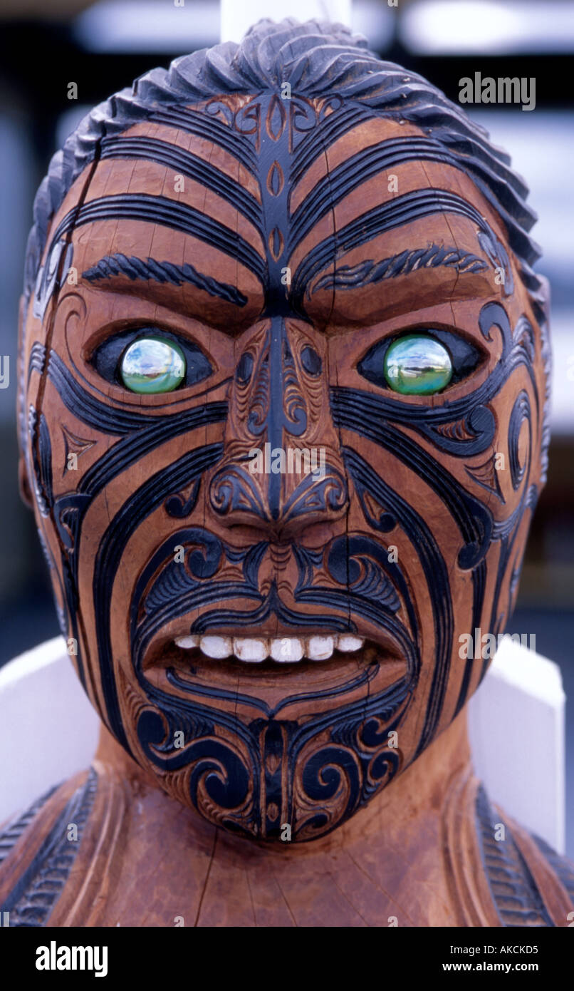 Traditional Maori carving showing face of a warrior Rotorua New Zealand Stock Photo