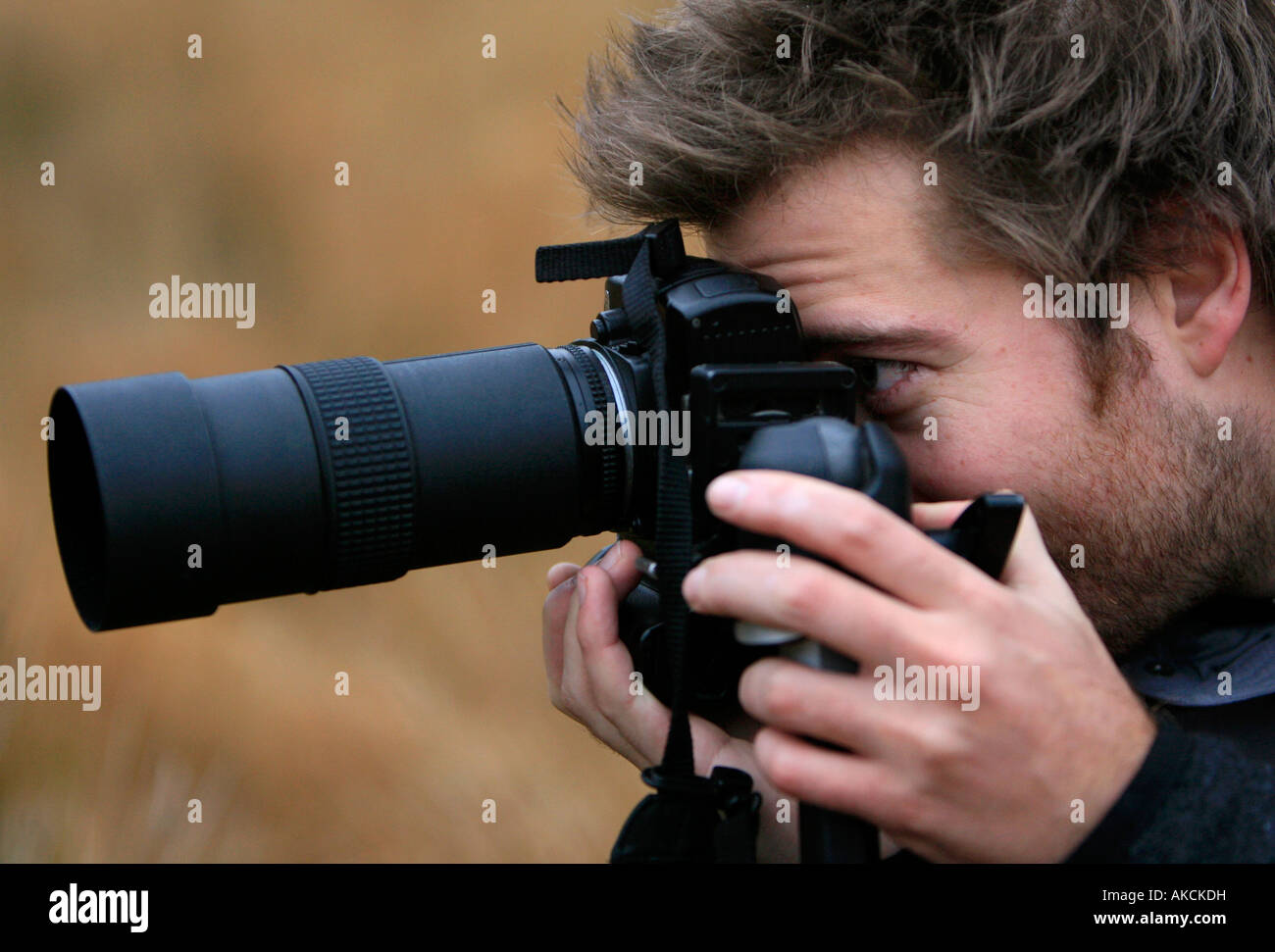Close-up of a man taking a picture with an SLR camera Stock Photo - Alamy