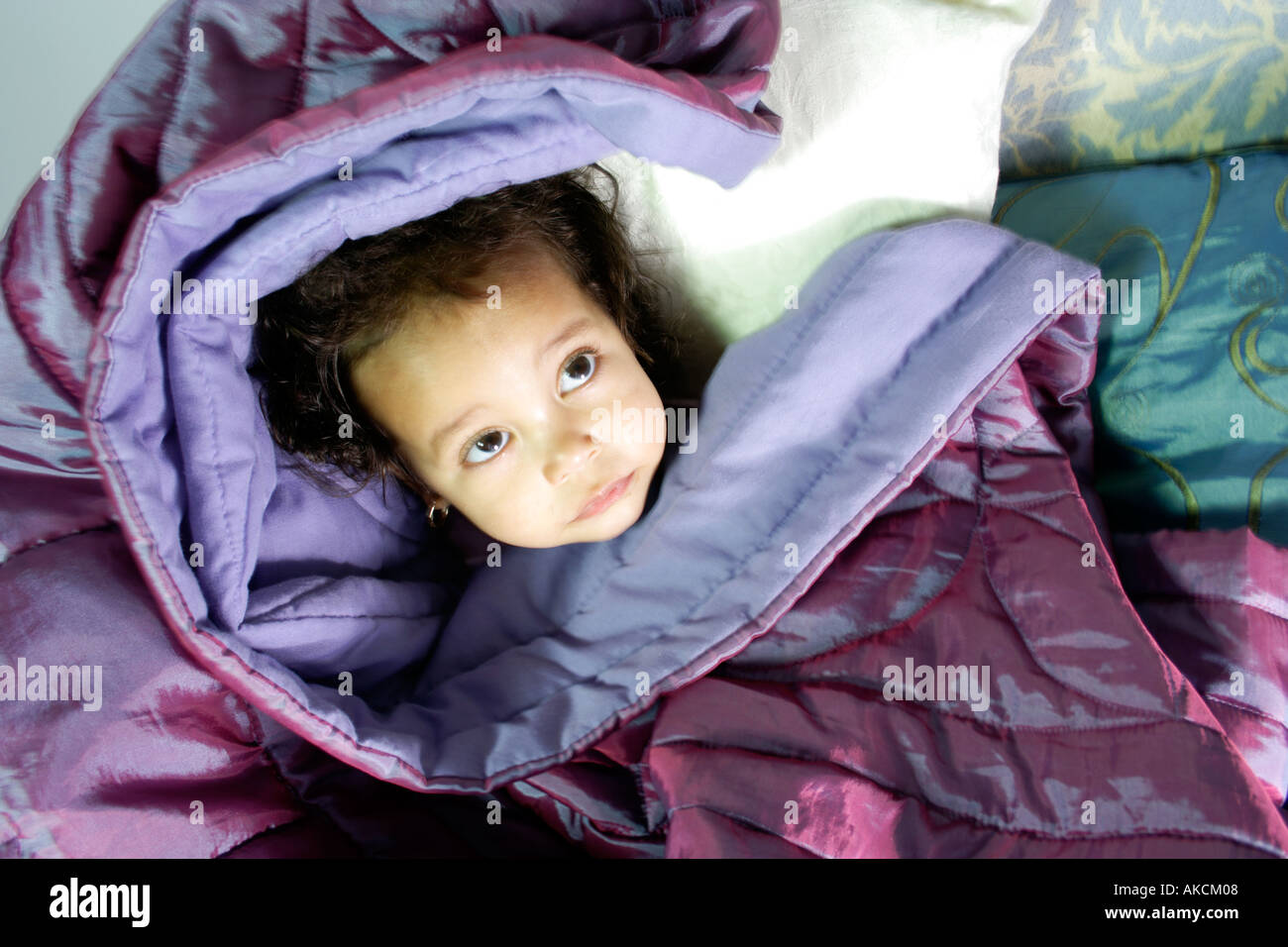 Young baby toddler aged 1 or 2 wrapped in a blanket head shot only