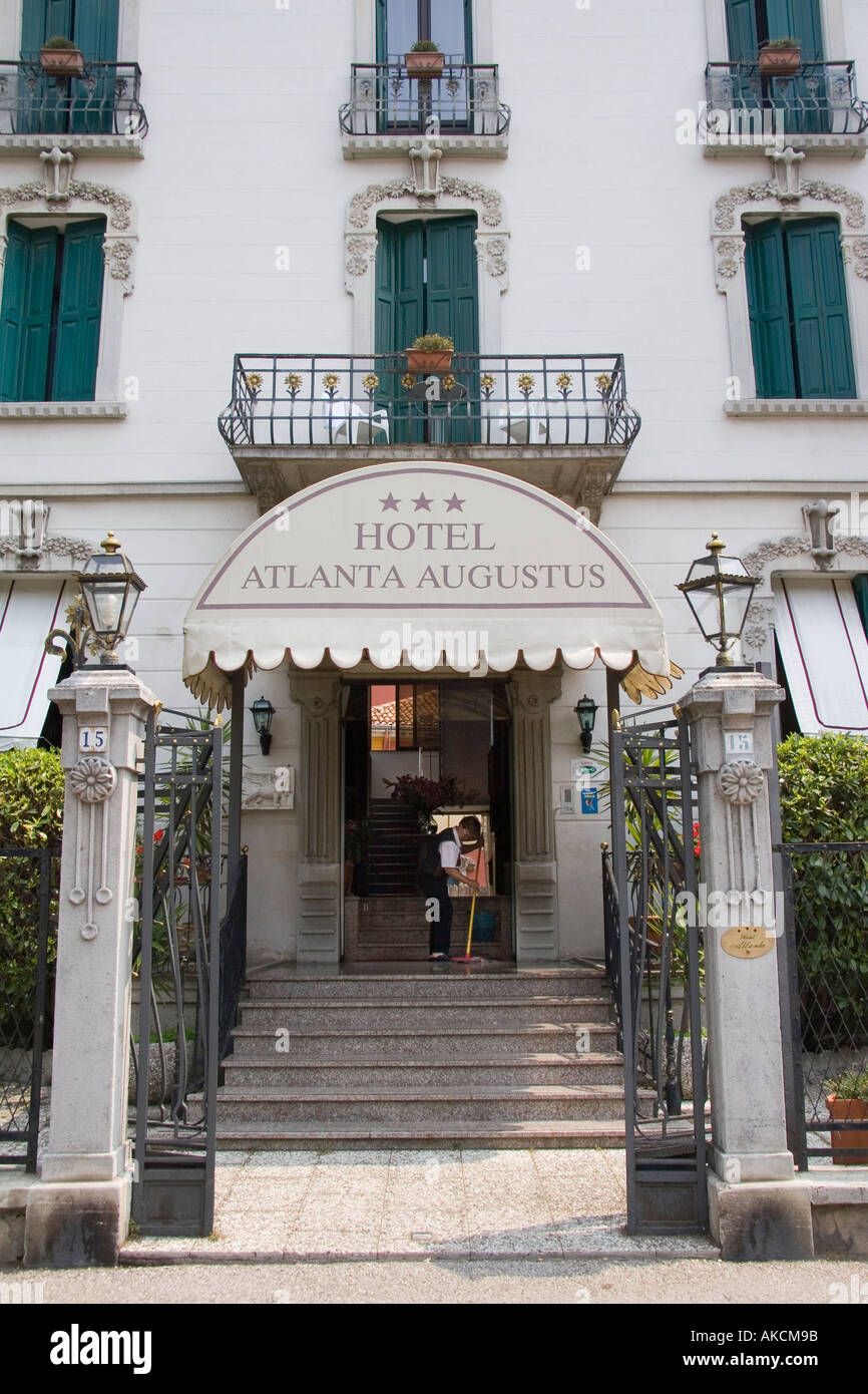 Woman sweeps entrance floor at the Hotel Alanta Agustus on the island of Lido Venice Italy Stock Photo