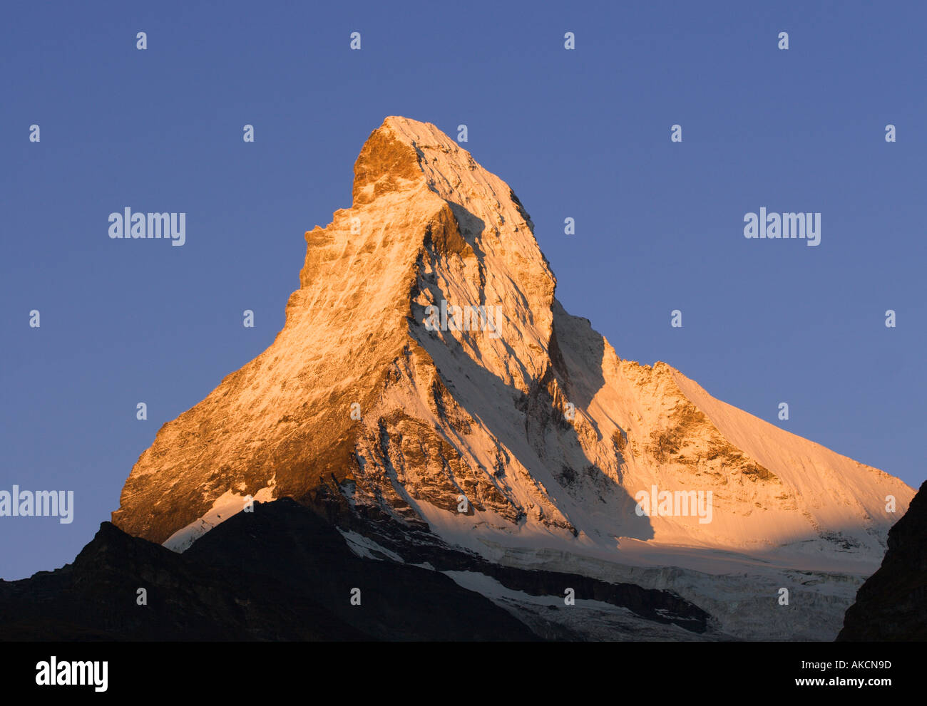 Peak of Matterhorn mountain glowing at sunrise in first light of dawn viewed from Zermatt The Swiss Alps Valais Switzerland Stock Photo