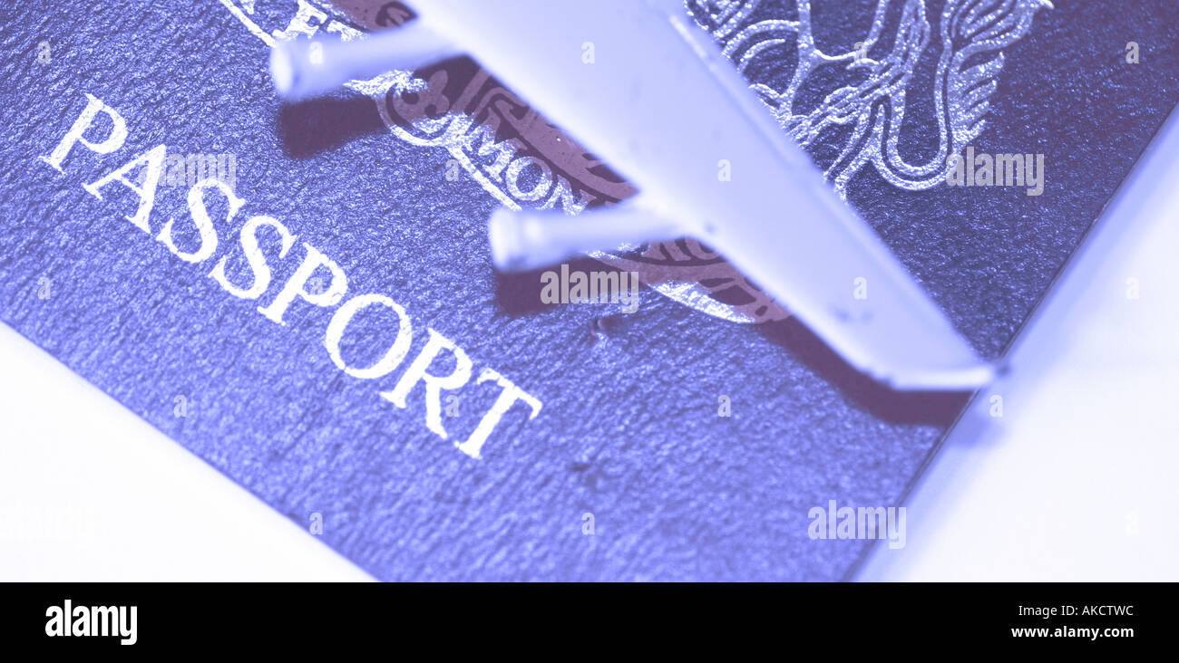 A Stock Photograph of a passport with a model plane on top representing international travel Stock Photo