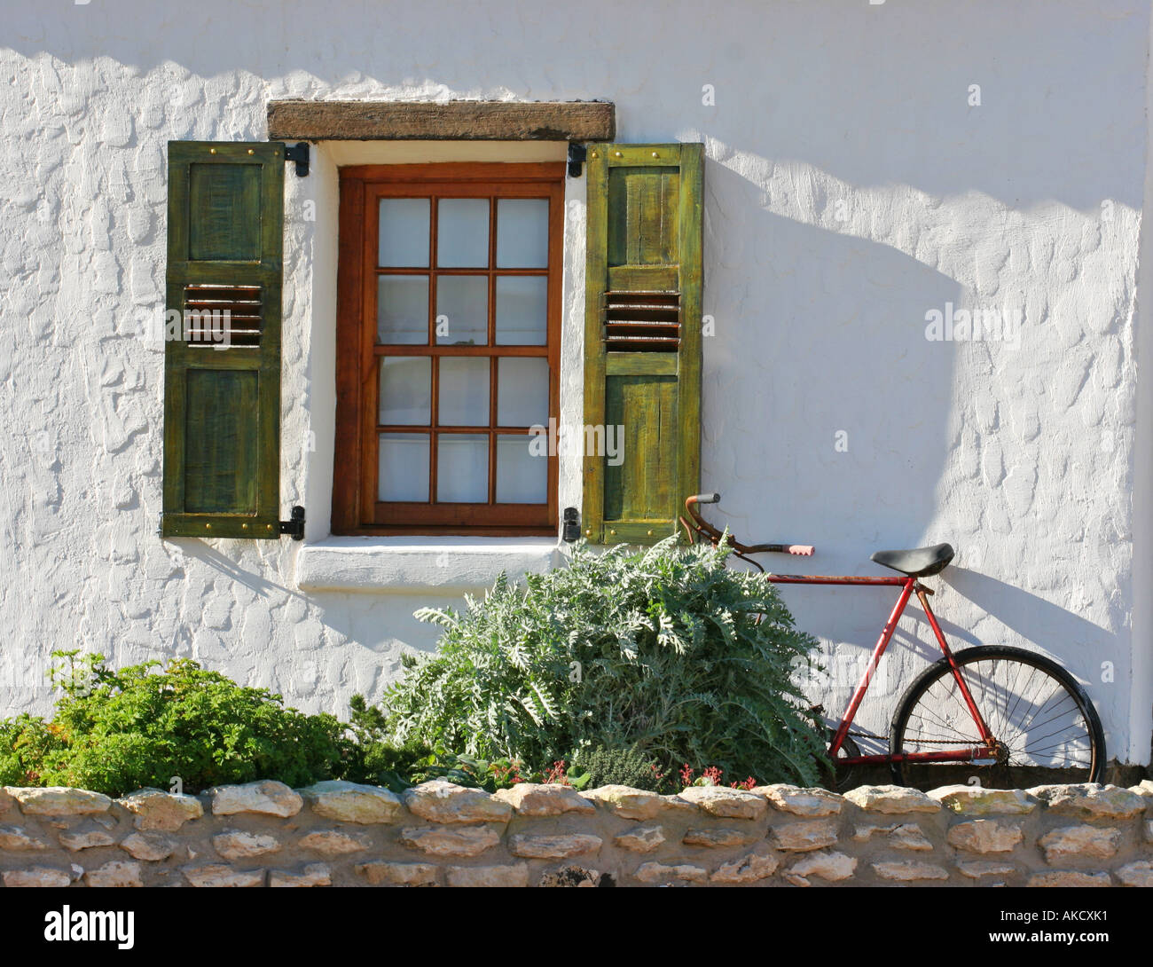 Shuttered window and bicycle Stock Photo