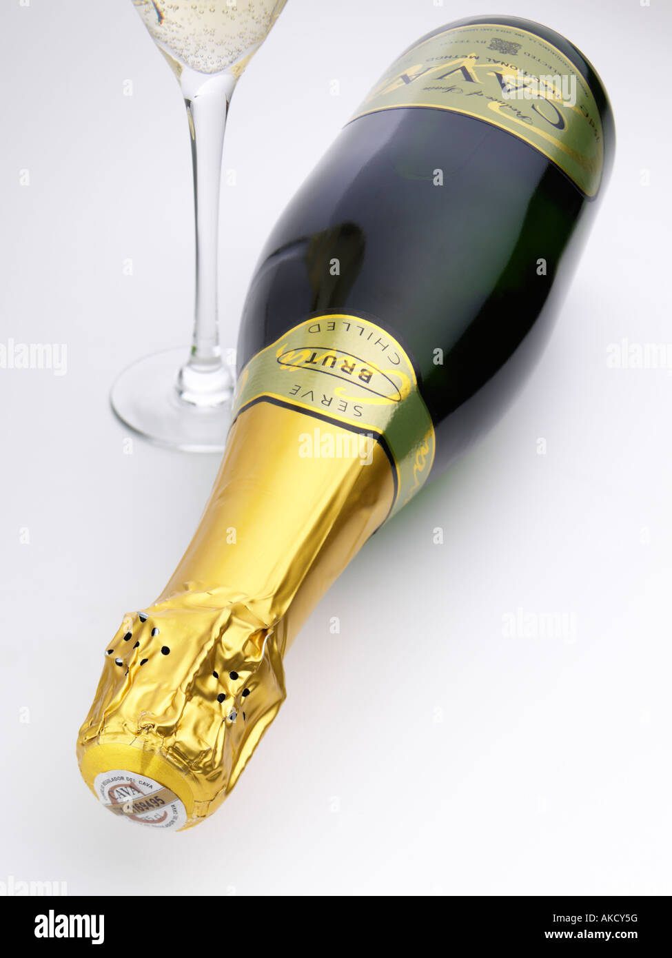 A bottle and glass of Spanish sparkling wine cava on a white background