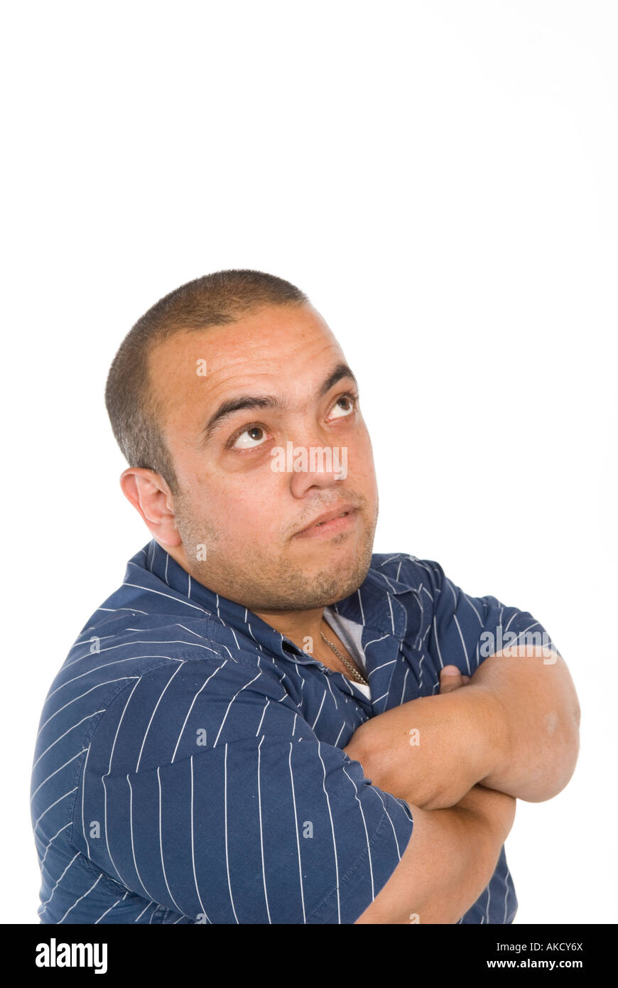 Midget male arms folded looking up thinking Stock Photo