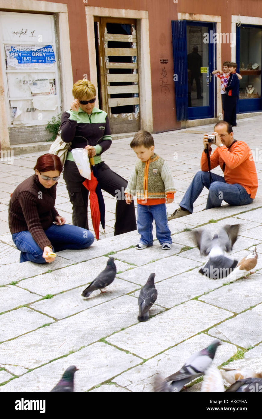 South-East Europe, Croatia, Sibenik, family with child (2-3) feeding pigeons Stock Photo