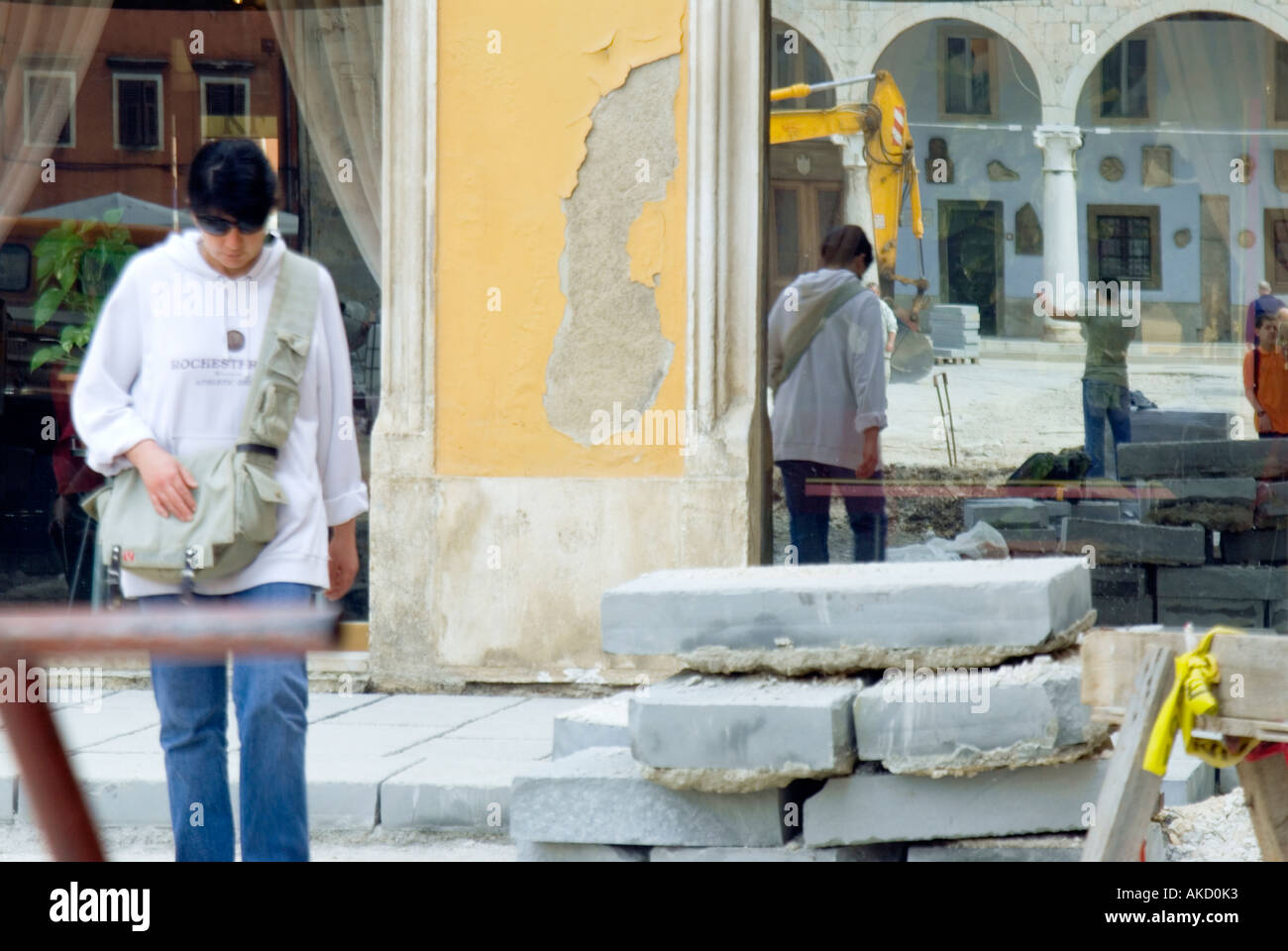 Croatia, Istria, Pula, woman walking on construction site on town street Stock Photo