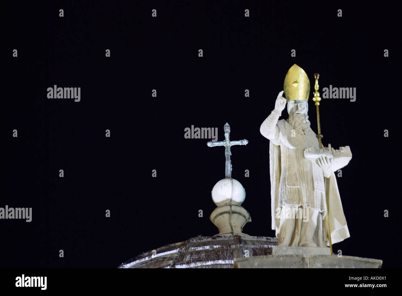 South-East Europe, Croatia, Dubrovnik, religious statue on roof of St Blaise church at night Stock Photo