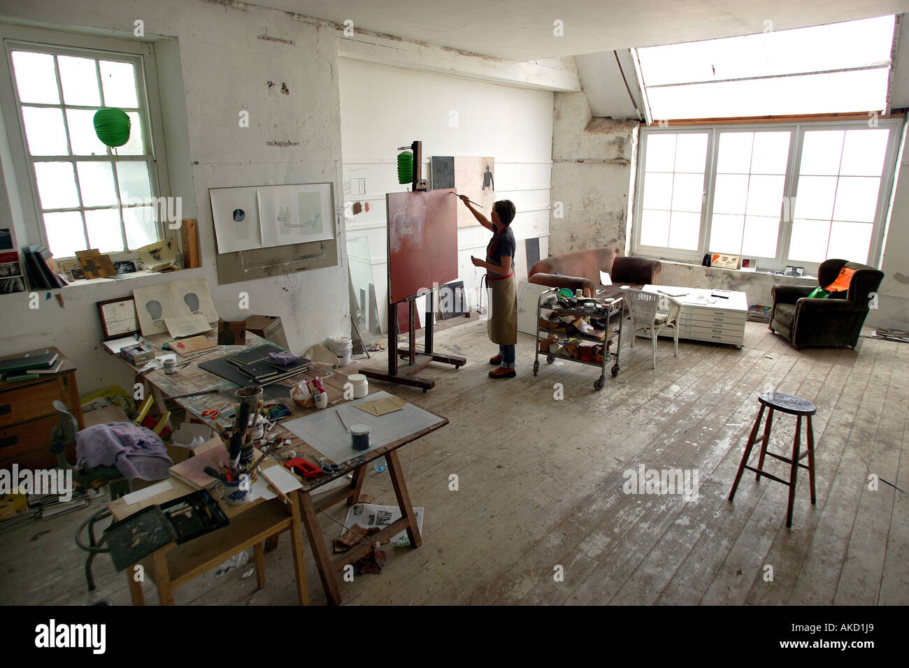 A painter at work in one of St Ives artists studios on Porthmeor Beach in Cornwall Stock Photo