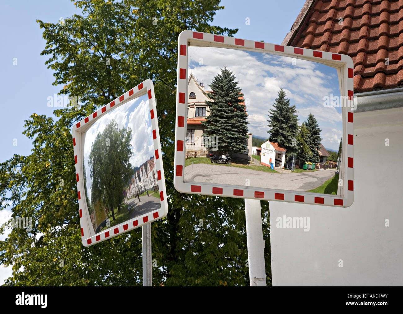 Convex mirrors used to help traffic see around corners Holasovice Bohemia Czech republic Stock Photo