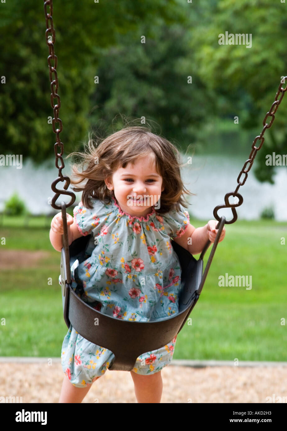 Happy 3 Year Old Girl Enjoying Swing On Playground Stock