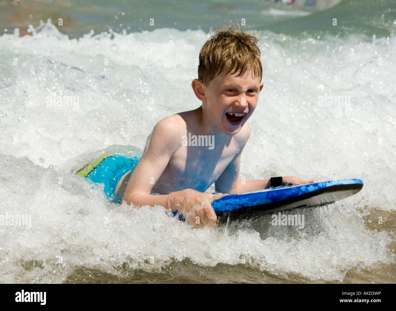Boy surfing on boogie board Stock Photo Alamy
