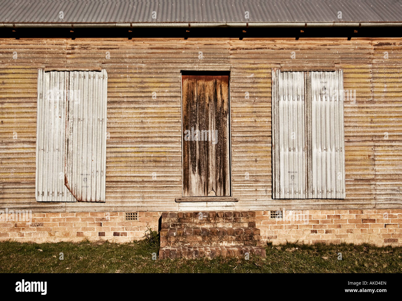 old farm building with boarded up windows Stock Photo