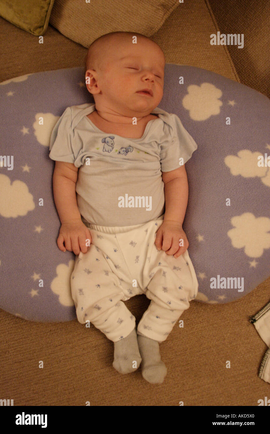 Newborn sleeping on top boppy