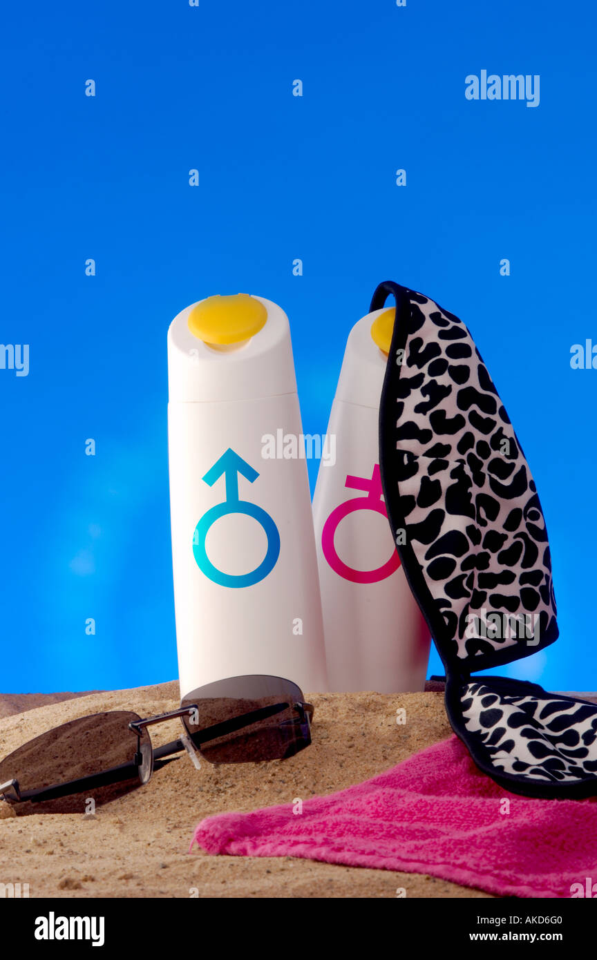Sun tan lotion bottles on beach with male female symbols and sunglasses