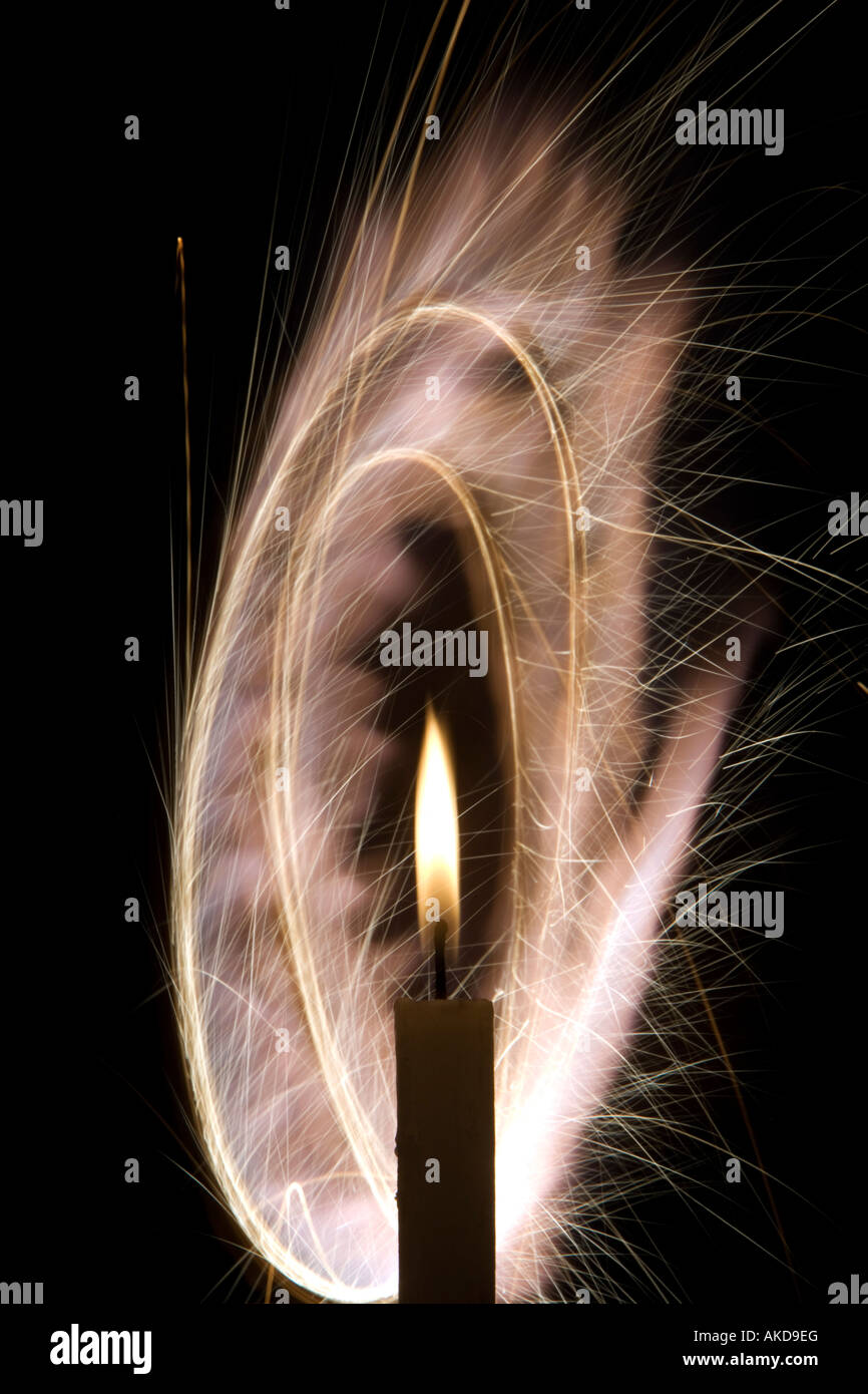 Candle light with circular light spark trails at night Stock Photo