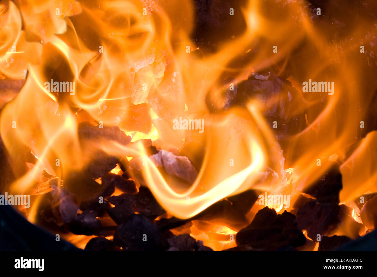 Burning coal with strong hot orange flames Stock Photo - Alamy