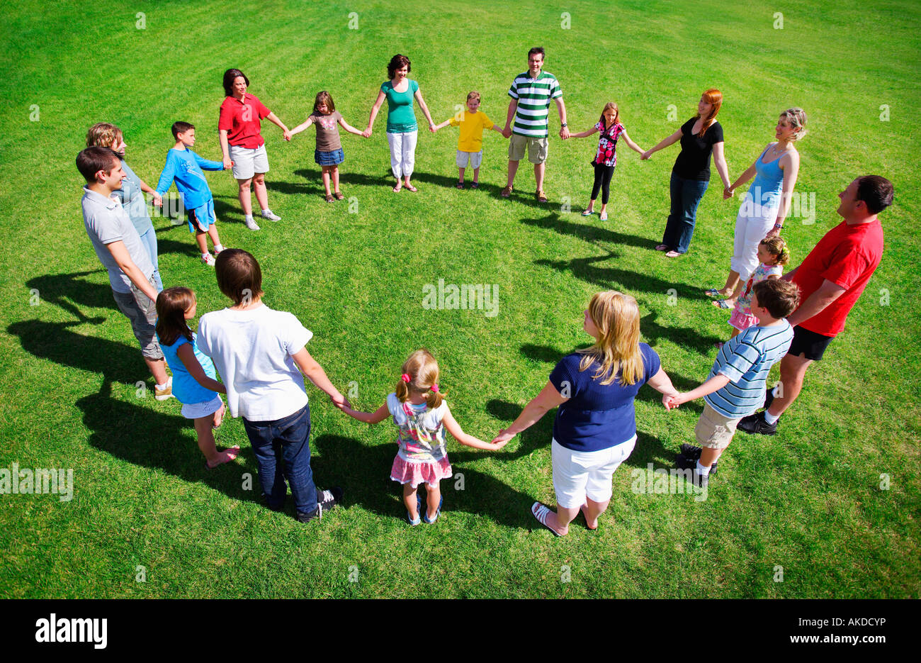 Group holding hands in a circle Stock Photo