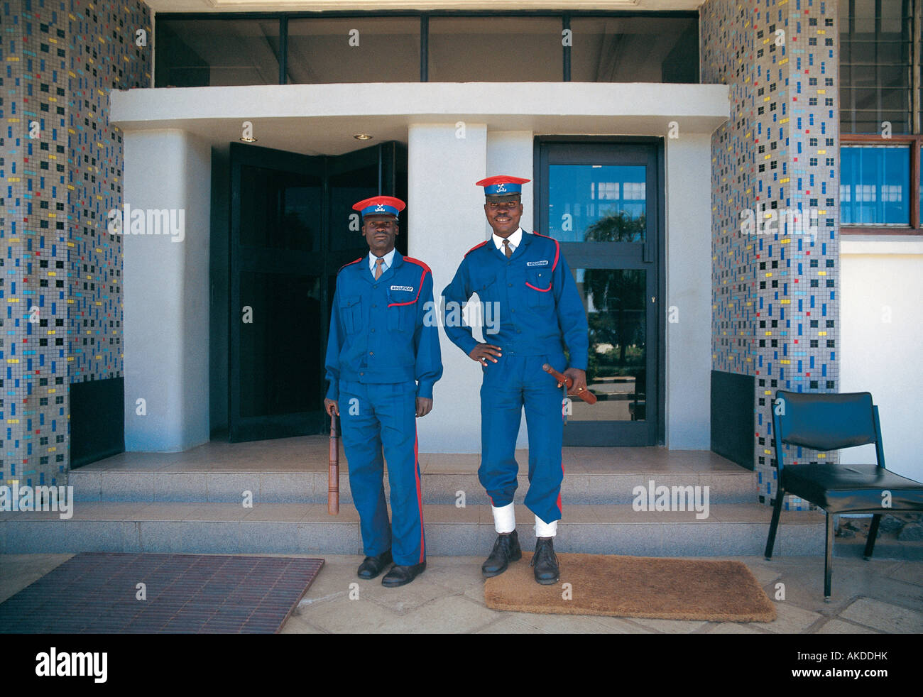 Two male Securicor guards or askaris at the entrance to Standard Chartered Bank Kisumu western Kenya East Africa Stock Photo