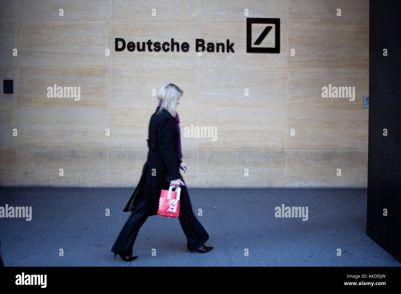 Businesswoman entering the Deutsche Bank building at lunchtime London England Britain UK Stock Photo