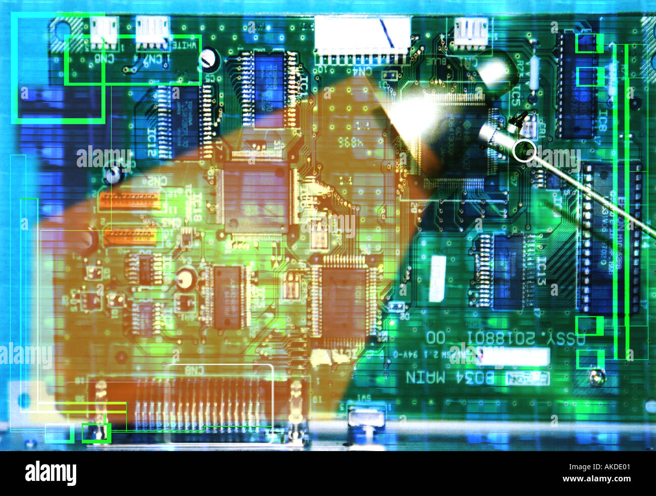 a computer circuit board lit up with an angle poise lamp Stock Photo ...