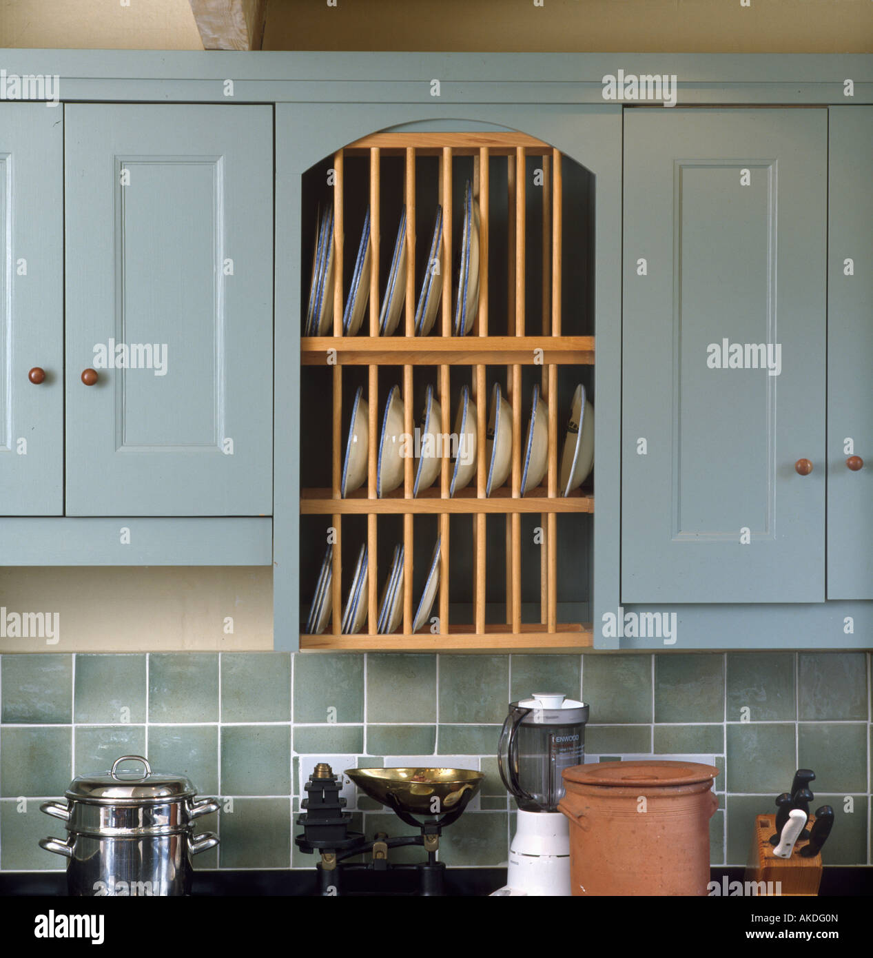 Close up of integral plate rack in pastel blue kitchen Stock Photo