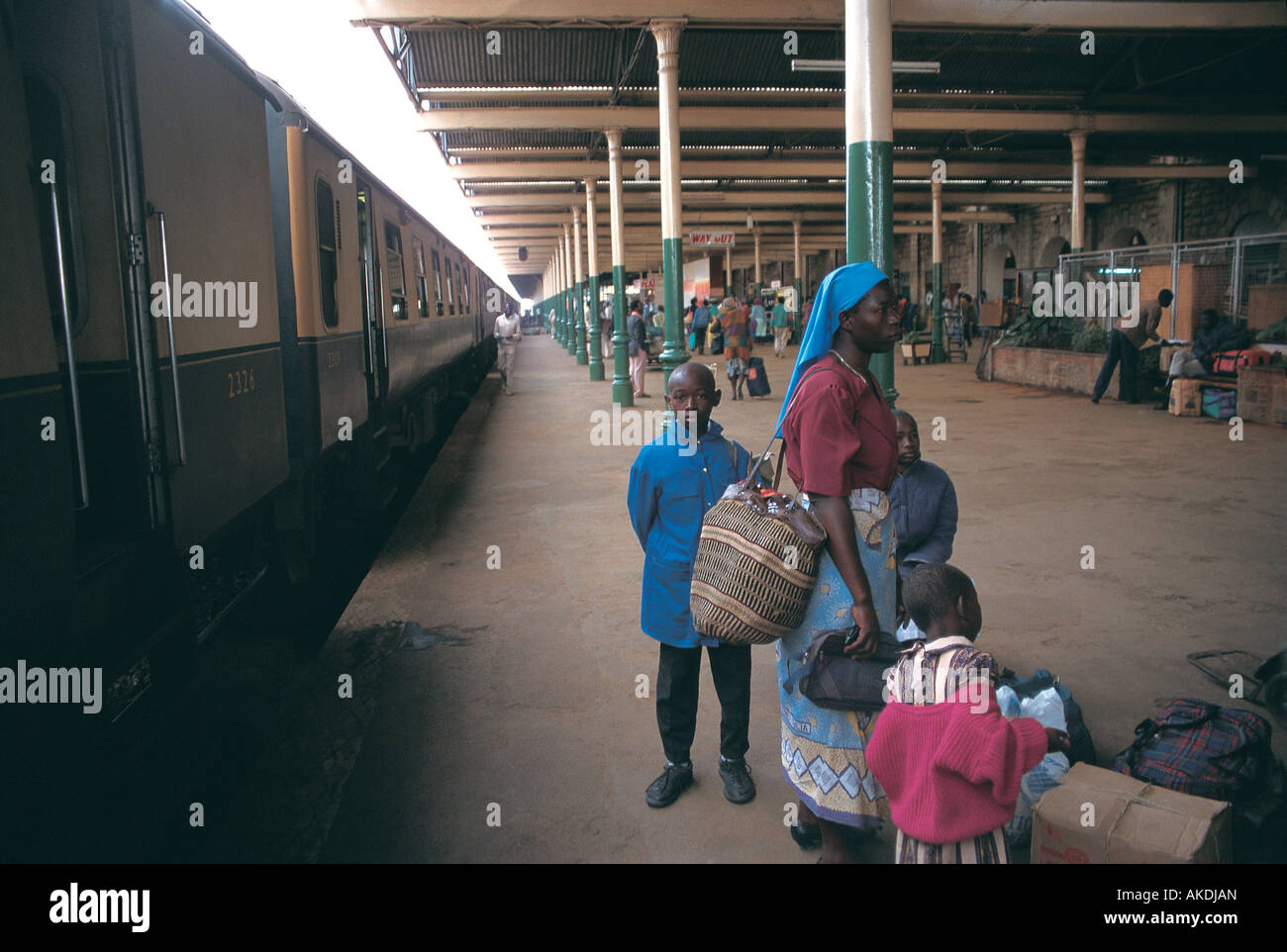 Nairobi Railway Station Platform Nairobi Kenya A passenger train is standing in the station A black African woman and children Stock Photo