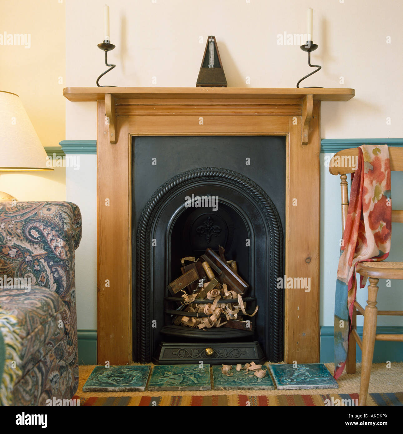 Reclaimed Pine Mantelpiece And Black Cast Iron Fireplace In Small
