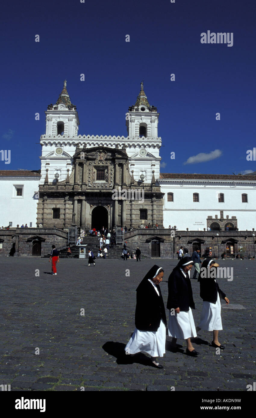 Three nuns crossing Plaza San Francisco in the Old Town, Quito, Ecuador Stock Photo