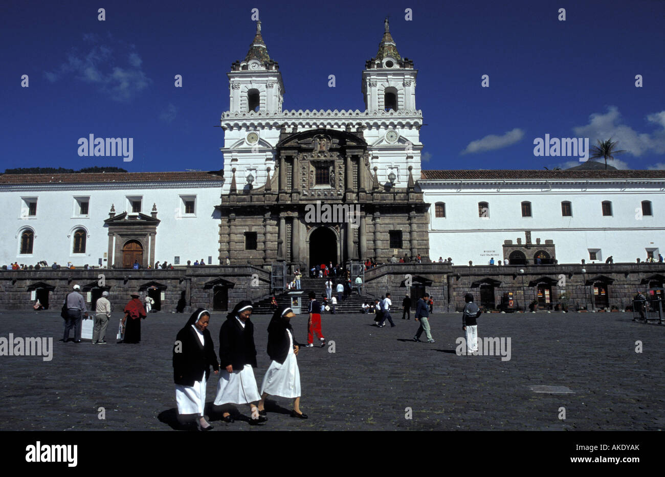 Three nuns crossing Plaza San Francisco in the Old Town, Quito, Ecuador Stock Photo