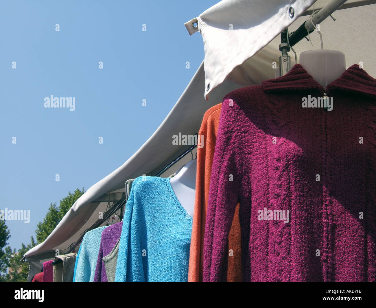 jumpers hanging on market stall  Stock Photo