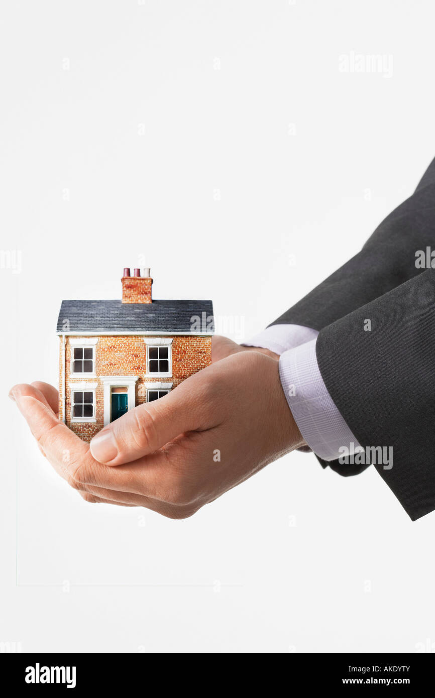 Business man holding model house in cupped hands, view of hands Stock ...
