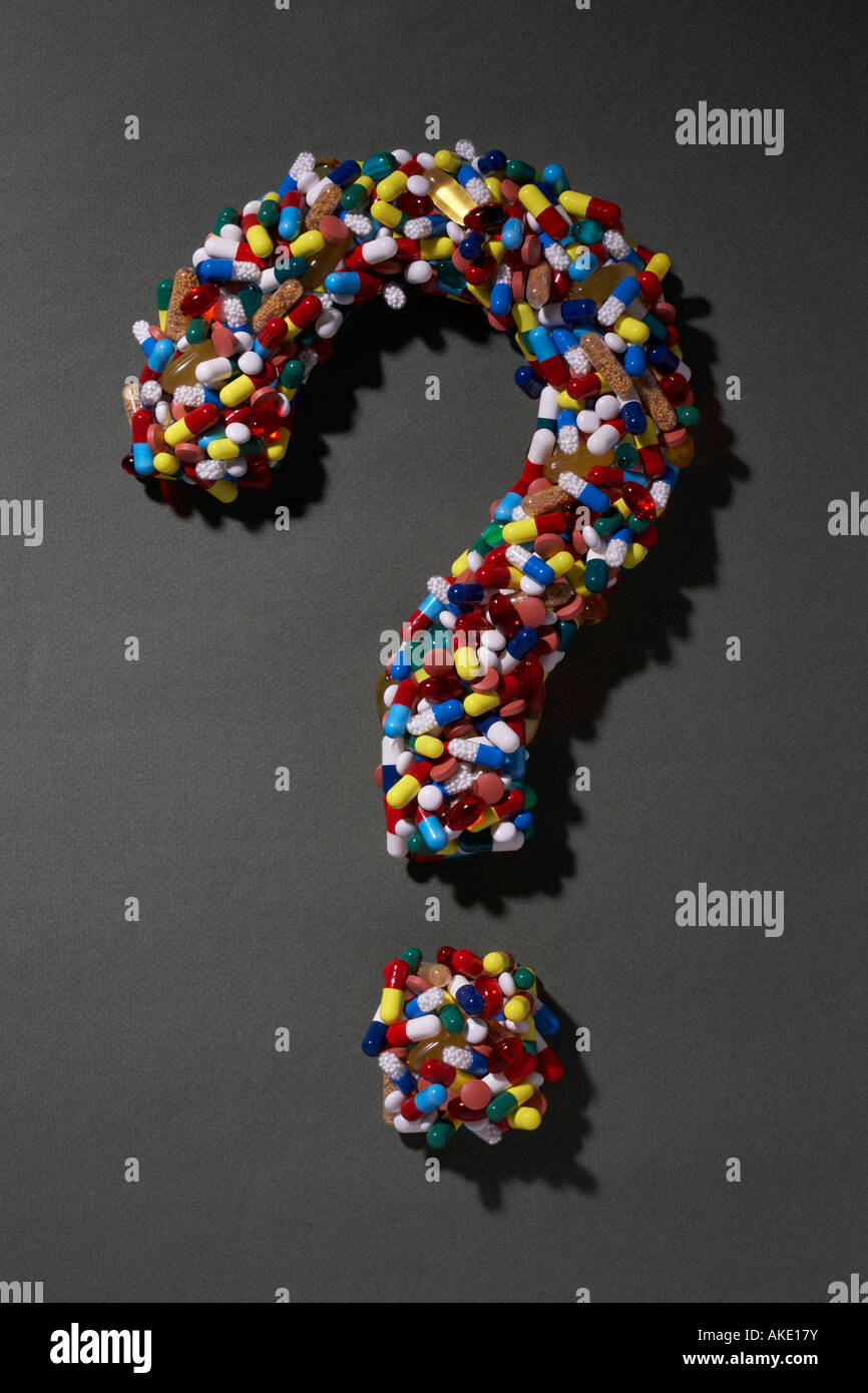 Various pills forming question mark, on black background Stock Photo