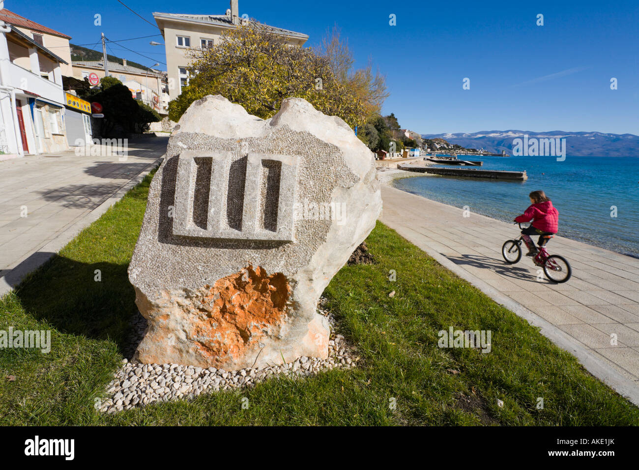 Glagolitic letter in Baska on Krk island, Croatia, cyclist is passing by Stock Photo
