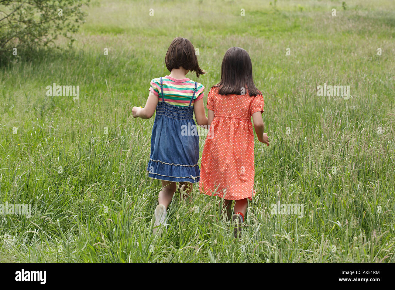 Two girls holding hands hi-res stock photography and images - Alamy