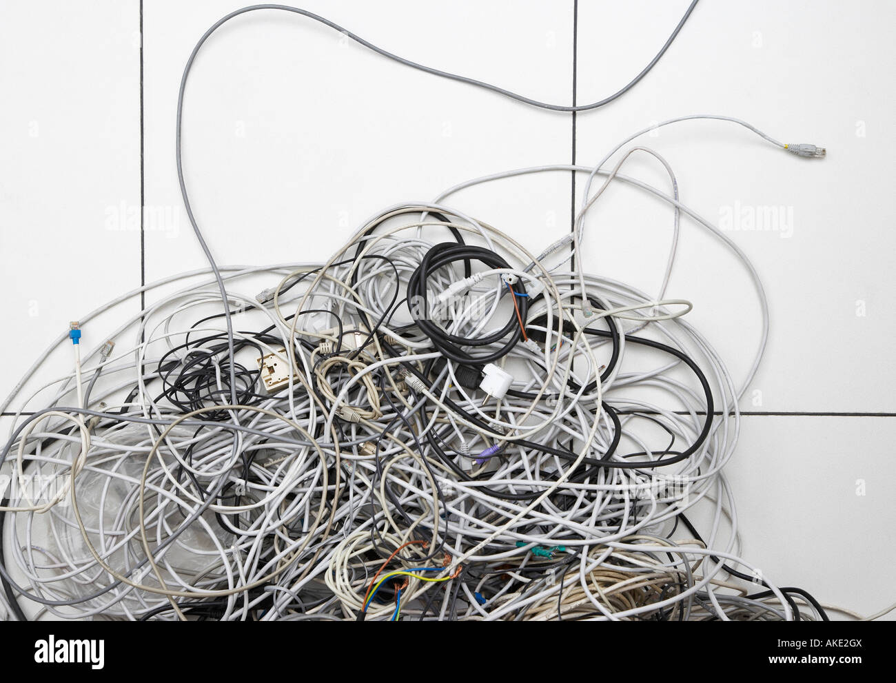 Tangle of computer wires in office Stock Photo - Alamy