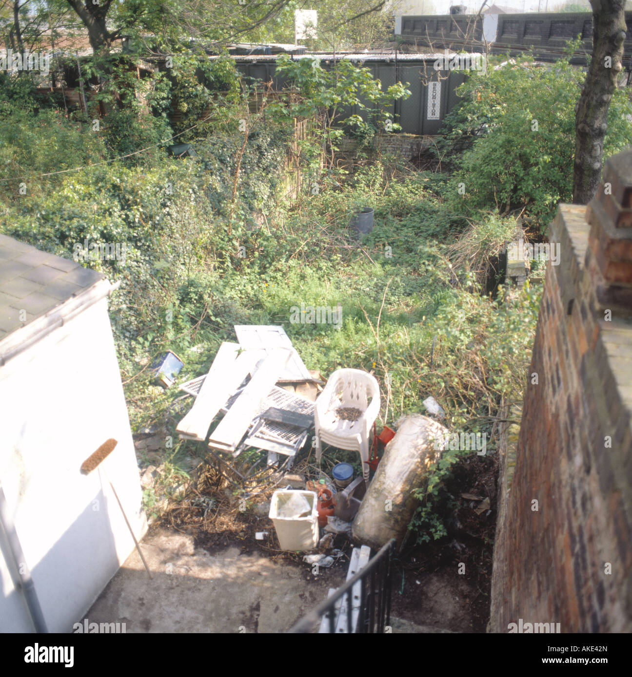 small back garden mess rubbish before untidy sequence east London Stock Photo