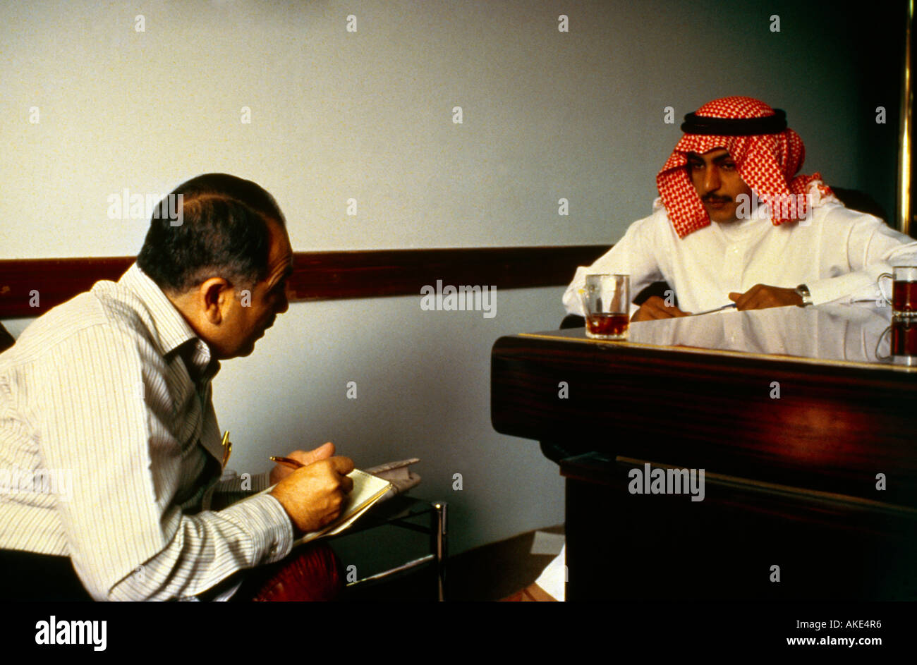 Saudi Arabia Interview Man In Dishdash Man In Western Dress Stock Photo