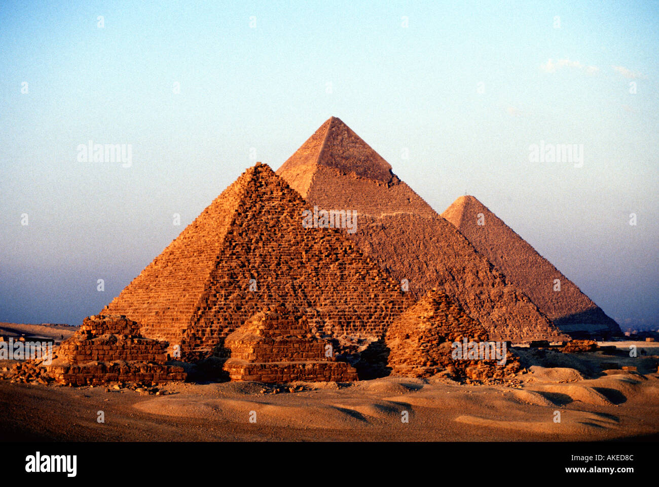 The Great Pyramids at Giza near Cairo Egypt appear golden at sunset Stock Photo