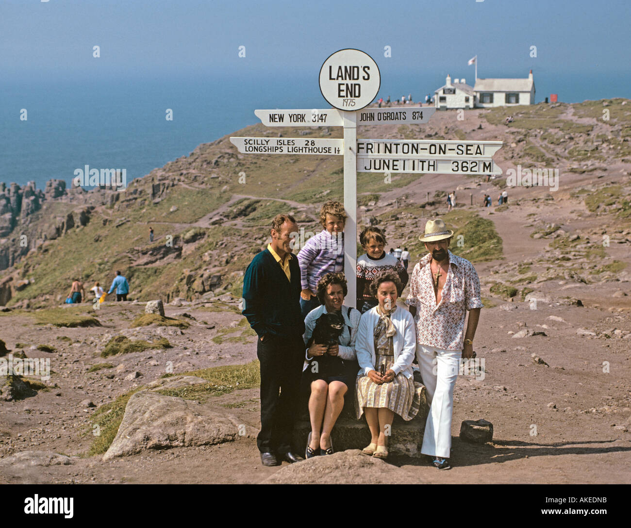 Visitors from Frinton pose for a souvenir photograph beneath the Lands End sign in 1975 Stock Photo