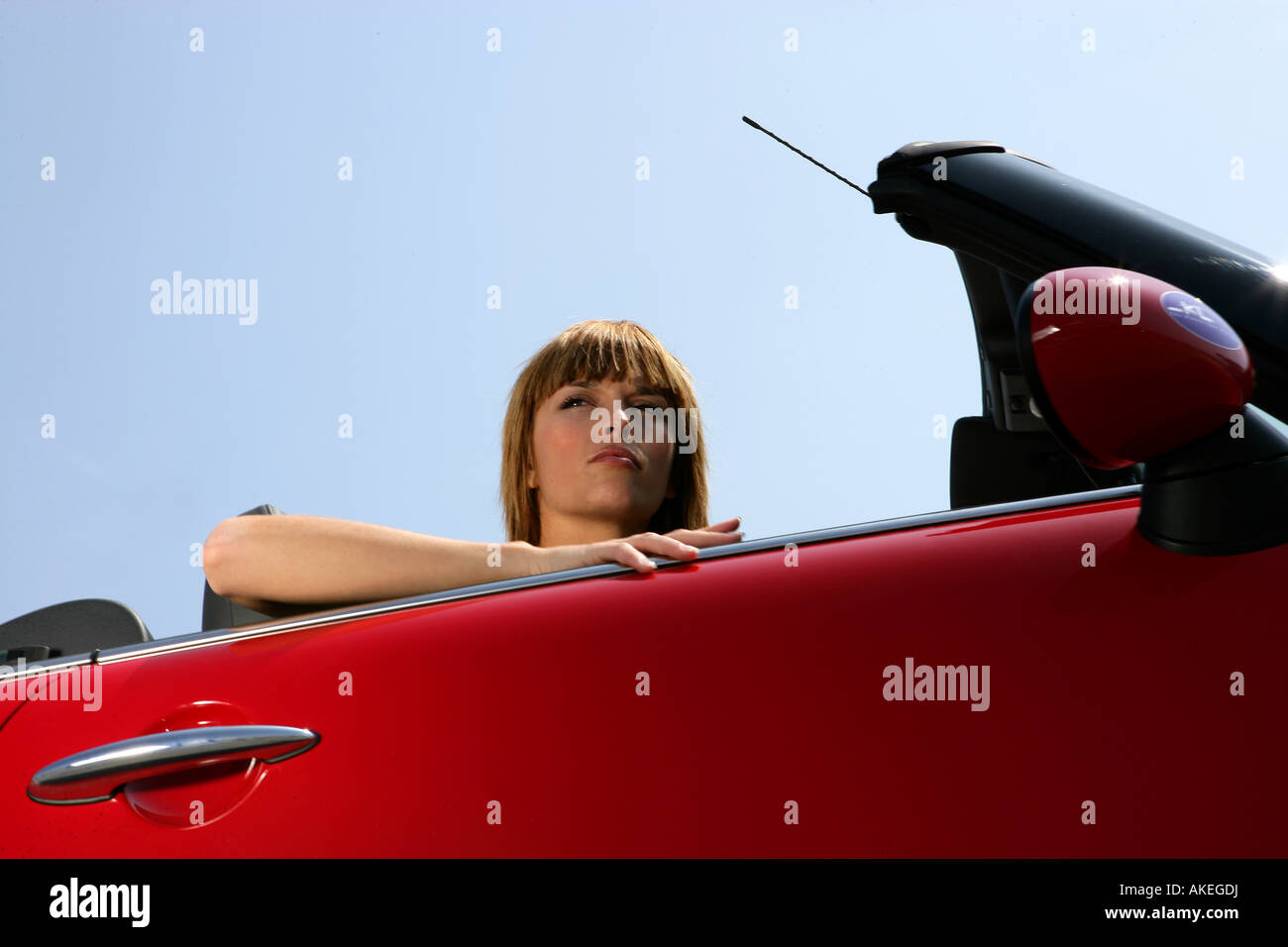 young woman in red car Stock Photo - Alamy