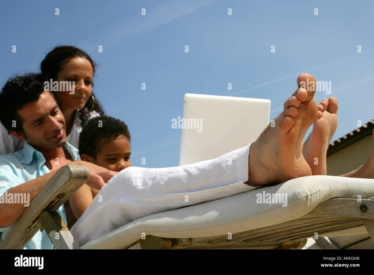 young couple with child and laptop computer Stock Photo