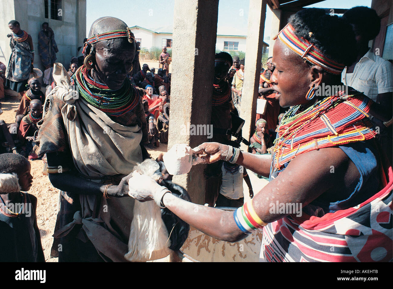 A Samburu woman handing out maize or corn flour at Laisamis Catholic Mission in northern Kenya East Africa Stock Photo
