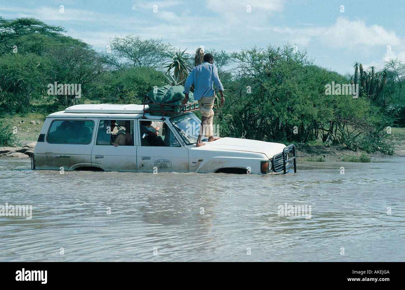 White four wheel drive safari vehicle stuck in the Olduvai River Tanzania East Africa Stock Photo