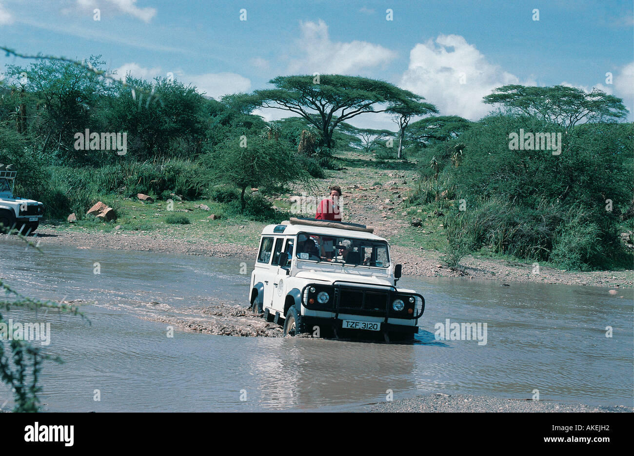 White four wheel drive safari vehicle stuck in the Olduvai River Tanzania East Africa Stock Photo