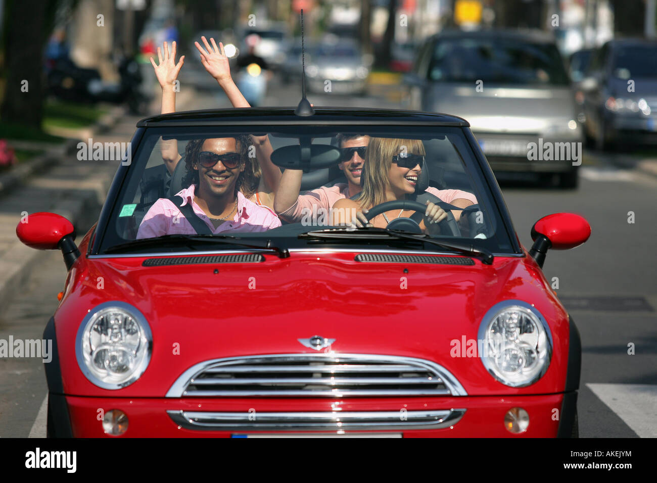friends in a red convertible car Stock Photo - Alamy