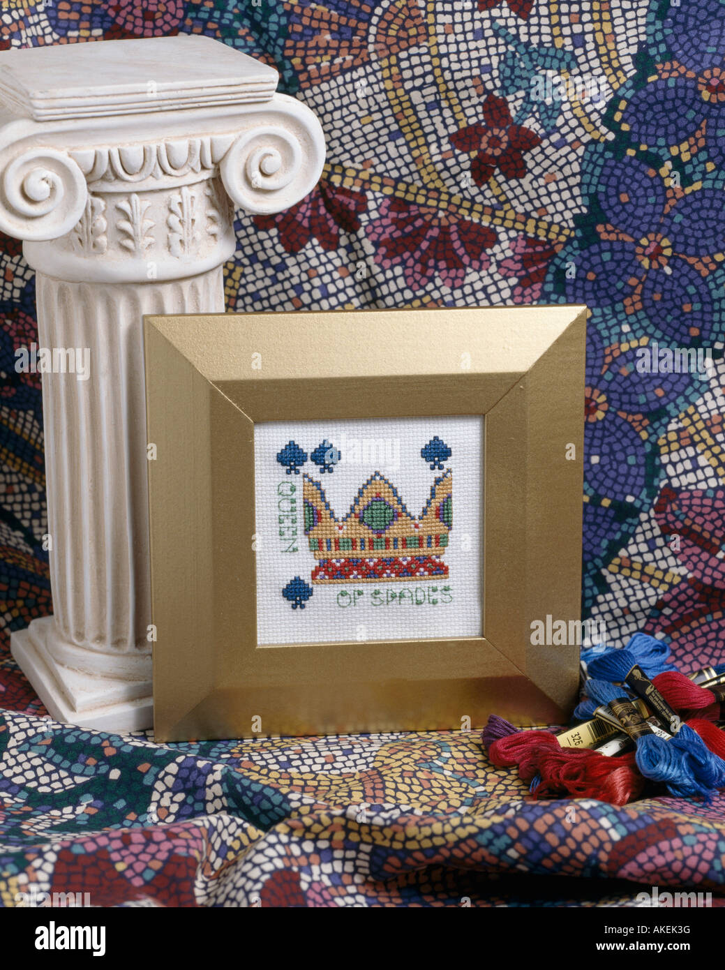 Cross stitch picture in gilt frame with miniature plaster "Corinthian